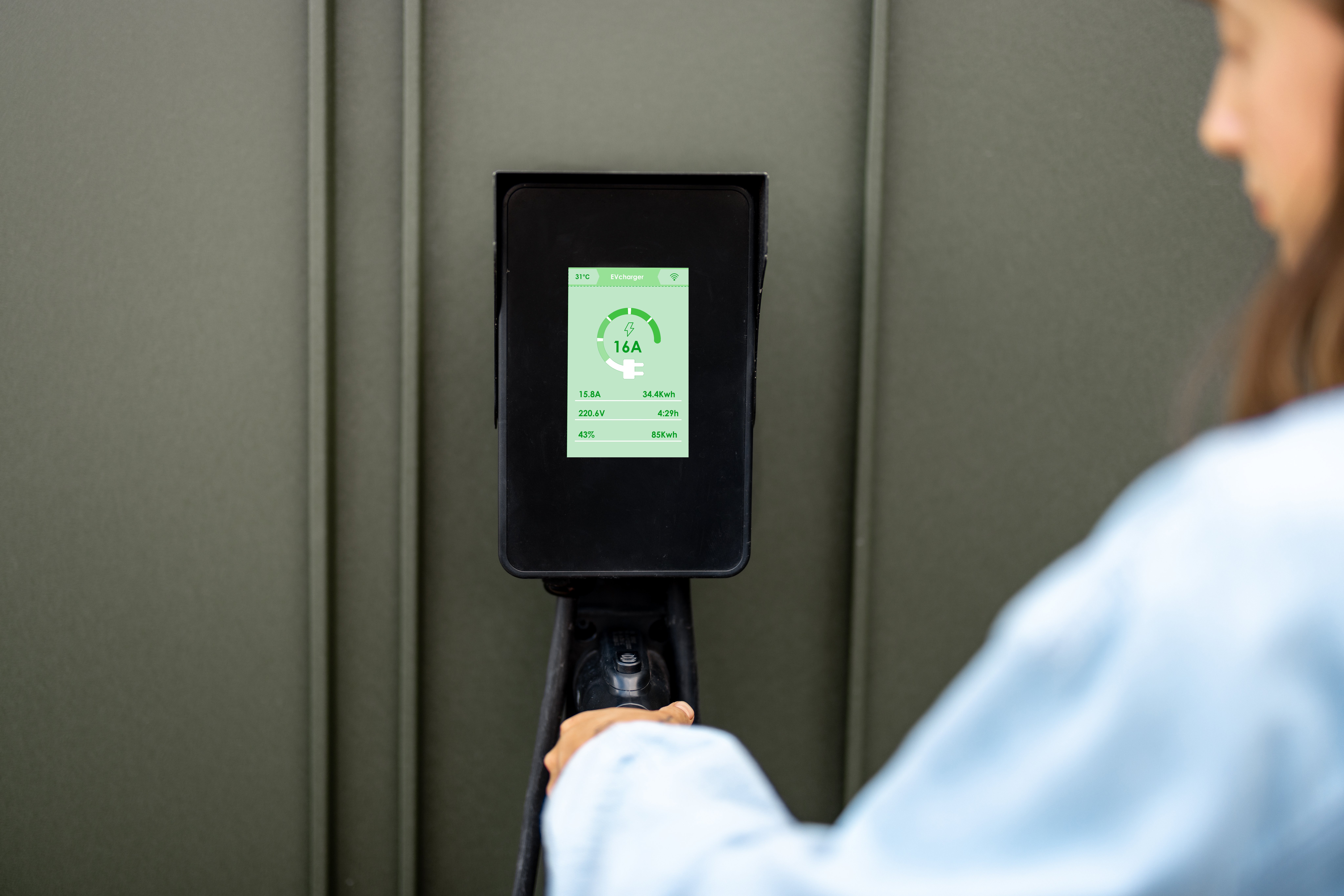 woman-takes-a-plug-of-a-charging-wall-station-2025-03-13-17-29-30-utc